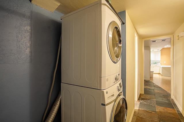 washroom with stacked washer and clothes dryer