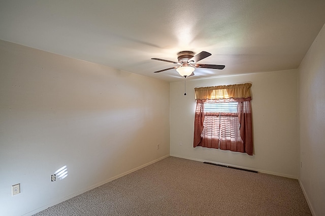 carpeted empty room featuring ceiling fan