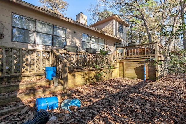 back of house with a wooden deck