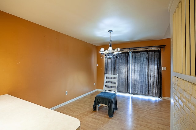 dining area featuring hardwood / wood-style flooring and a chandelier