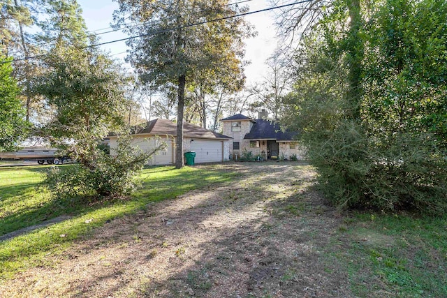 view of front of house with a front yard and a garage