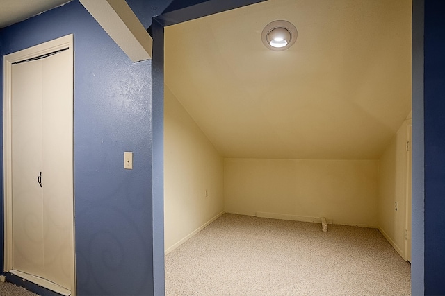 additional living space featuring carpet flooring and lofted ceiling