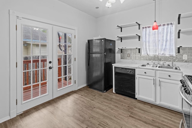 2695 Sandlin St, Beaumont, TX 77707 - kitchen featuring black appliances, a sink, open shelves, light wood-type flooring, and french doors