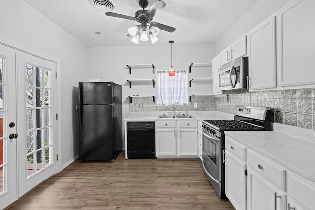 2695 Sandlin St, Beaumont, TX 77707 - kitchen with black appliances, open shelves, a sink, white cabinetry, and ceiling fan
