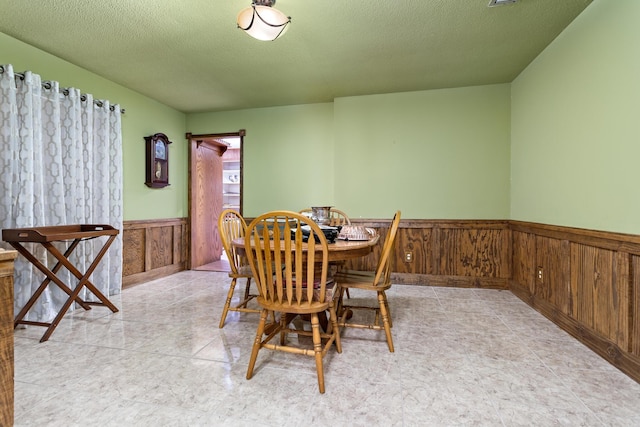 dining space with a textured ceiling