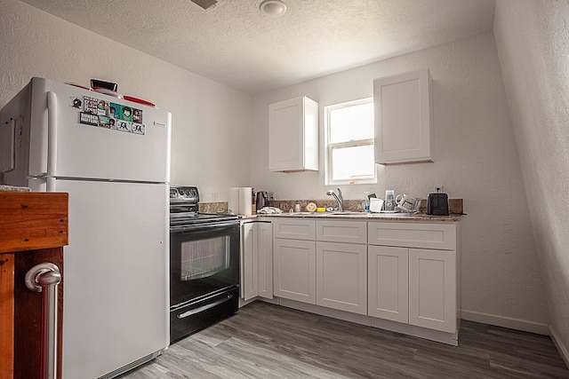 kitchen featuring sink, hardwood / wood-style flooring, white cabinetry, black range with electric stovetop, and white refrigerator