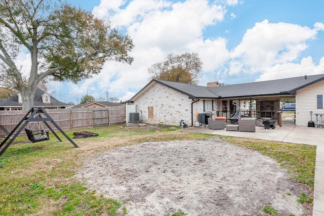 view of yard with an outdoor living space, cooling unit, and a patio area