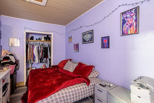 bedroom featuring dark wood-type flooring and a closet