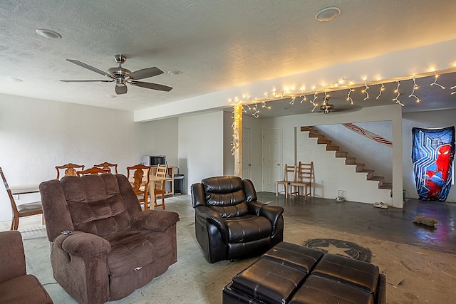 living room with ceiling fan, concrete floors, and a textured ceiling