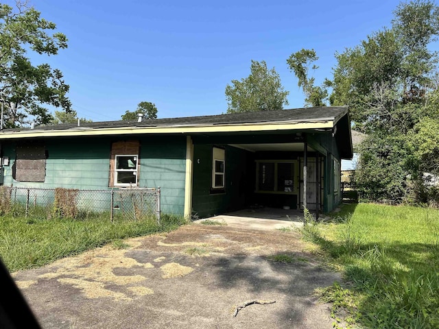 back of property with a carport