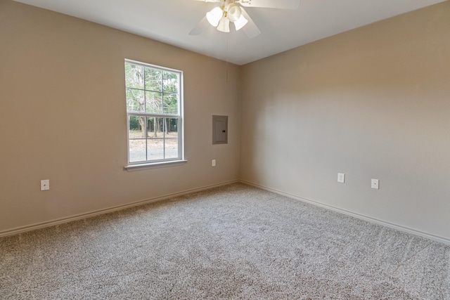 spare room featuring carpet, ceiling fan, and electric panel