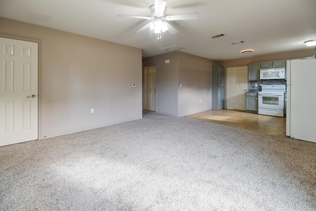 kitchen with decorative backsplash, carpet flooring, gray cabinetry, white appliances, and ceiling fan