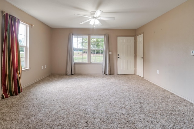 unfurnished room featuring carpet floors and ceiling fan