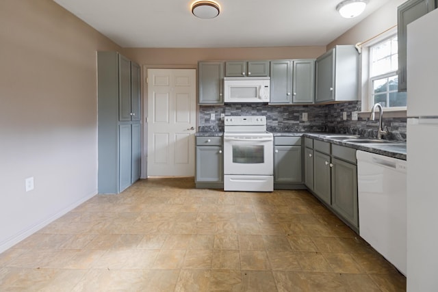 kitchen with white appliances, gray cabinets, backsplash, and sink