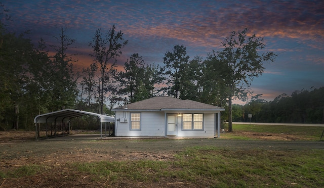 exterior space featuring a yard and a carport