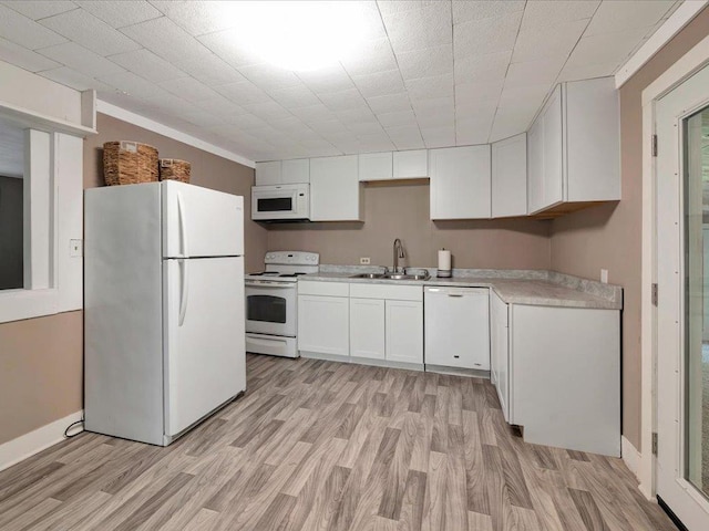 kitchen featuring white cabinetry, sink, white appliances, and light hardwood / wood-style flooring