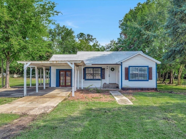 ranch-style house with a carport, a front lawn, and french doors