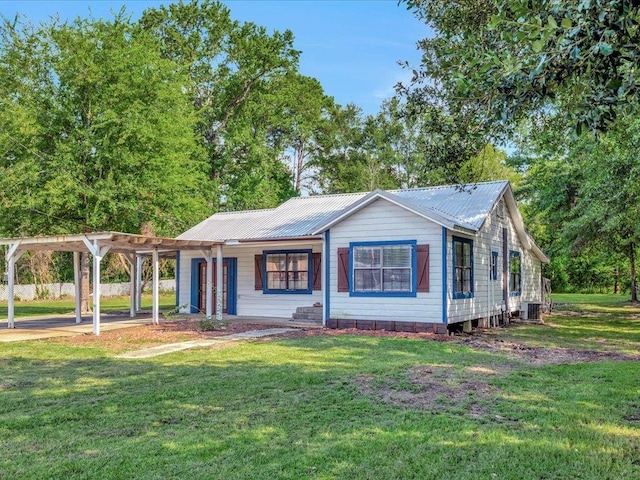 ranch-style house featuring a carport, a pergola, a front yard, and central air condition unit