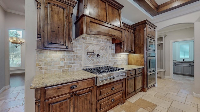 416 Birch View Dr, Lumberton, TX 77657 - kitchen featuring stainless steel appliances, stone tile flooring, crown molding, arched walkways, and decorative backsplash