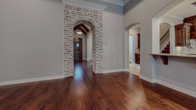 416 Birch View Dr, Lumberton, TX 77657 - unfurnished room with dark wood-style flooring, arched walkways, baseboards, and crown molding
