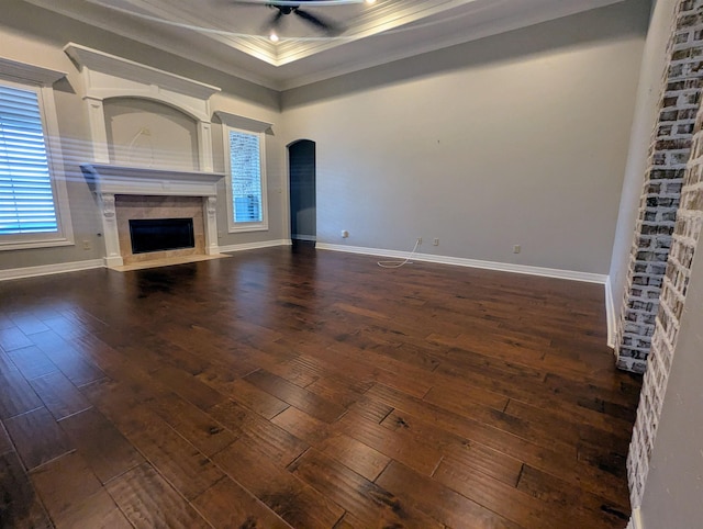416 Birch View Dr, Lumberton, TX 77657 - unfurnished living room featuring crown molding, dark wood finished floors, arched walkways, a premium fireplace, and ceiling fan