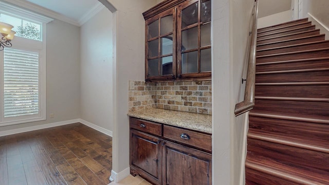 416 Birch View Dr, Lumberton, TX 77657 - kitchen featuring ornamental molding, dark brown cabinets, tasteful backsplash, light stone counters, and dark wood-style floors