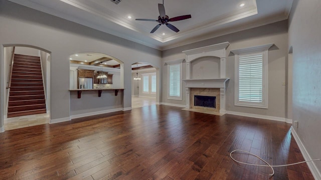 416 Birch View Dr, Lumberton, TX 77657 - unfurnished living room with crown molding, a ceiling fan, hardwood / wood-style flooring, a tray ceiling, and a fireplace