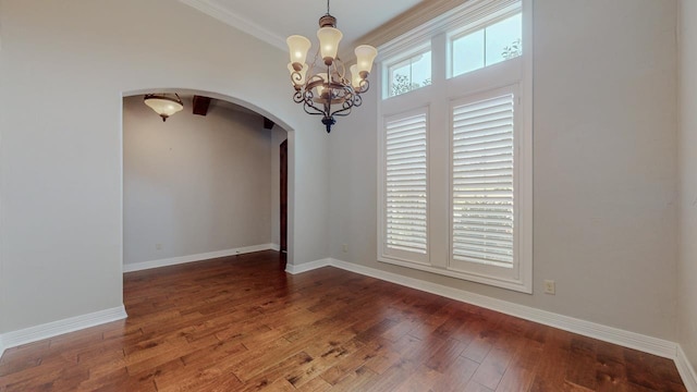 416 Birch View Dr, Lumberton, TX 77657 - unfurnished dining area featuring arched walkways, a chandelier, wood finished floors, baseboards, and ornamental molding