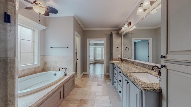 416 Birch View Dr, Lumberton, TX 77657 - bathroom with stone tile floors, a bath, double vanity, a ceiling fan, and ornamental molding