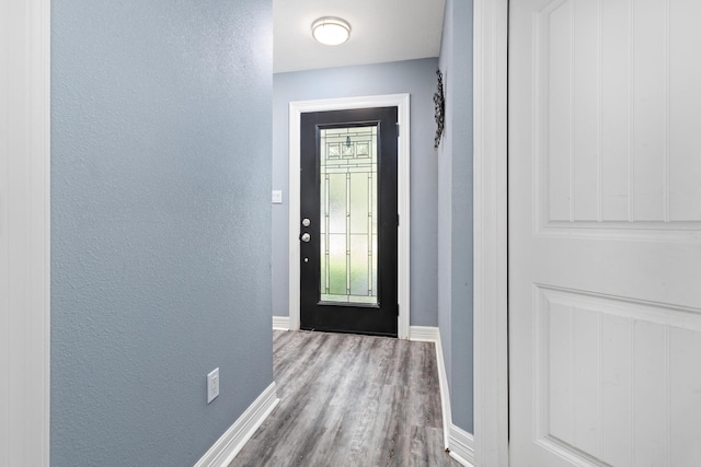 12945 Westchester Ln, Beaumont, TX 77713 - doorway to outside featuring wood finished floors, baseboards, and a textured wall