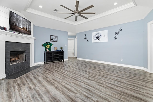 12945 Westchester Ln, Beaumont, TX 77713 - unfurnished living room featuring a raised ceiling, ceiling fan, wood finished floors, baseboards, and recessed lighting