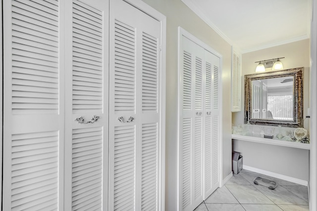 bathroom with a closet and ornamental molding