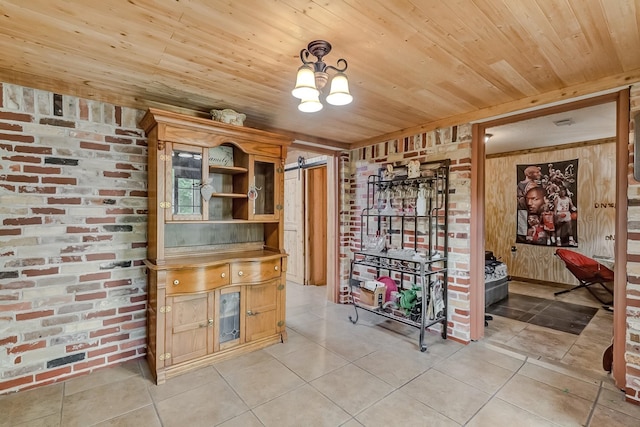 wine room featuring wooden ceiling, light tile patterned floors, a barn door, brick wall, and wood walls