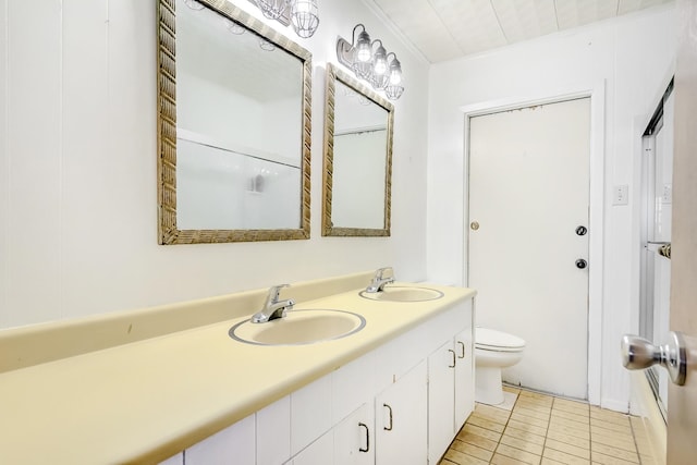 bathroom with toilet, tile patterned flooring, and double vanity