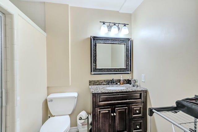 full bath featuring toilet, vanity, and a shower