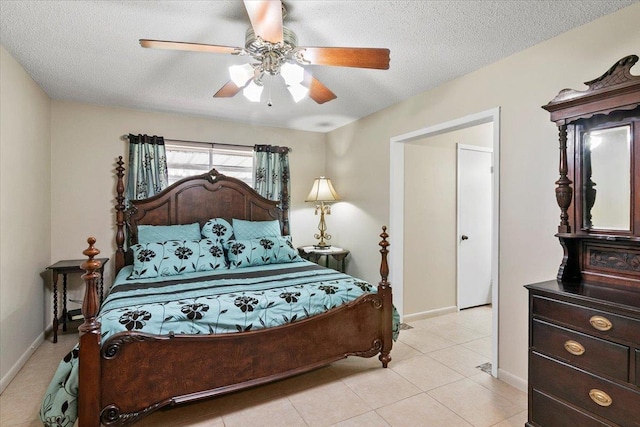 tiled bedroom featuring ceiling fan and a textured ceiling