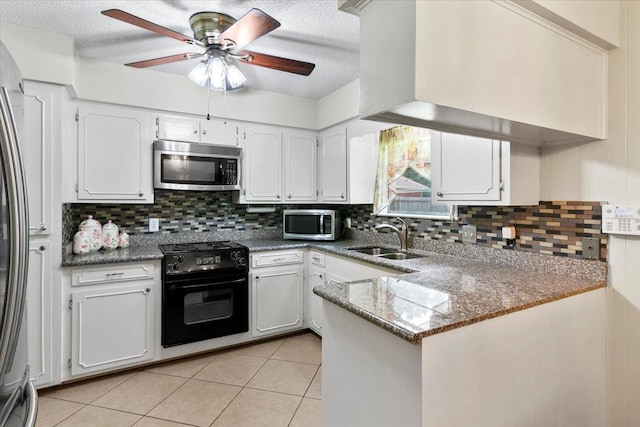 kitchen featuring kitchen peninsula, sink, white cabinets, and stainless steel appliances