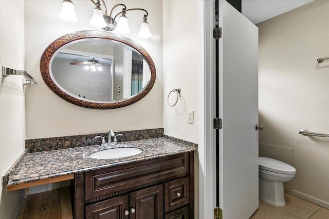 bathroom featuring tile patterned floors, vanity, a textured ceiling, ceiling fan, and toilet