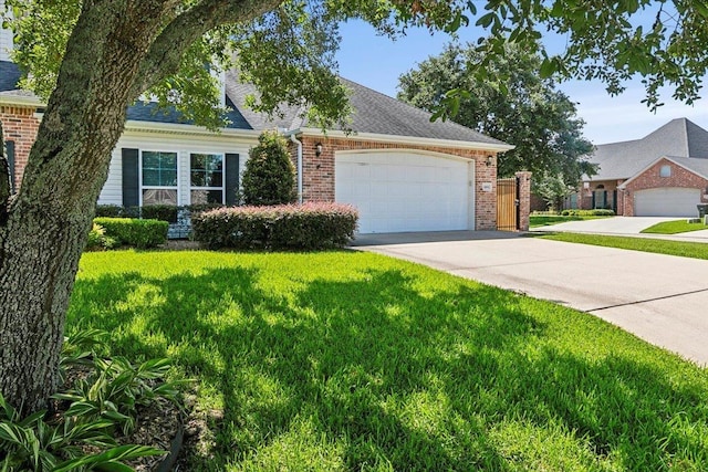 view of front of home with a garage, driveway, brick siding, and a front yard