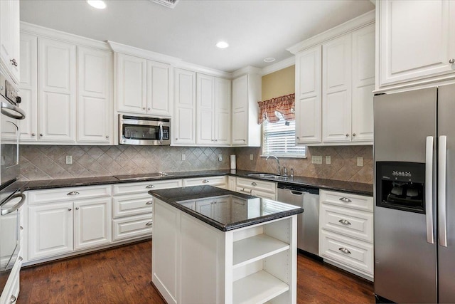 kitchen featuring dark wood-style floors, open shelves, appliances with stainless steel finishes, white cabinetry, and a sink