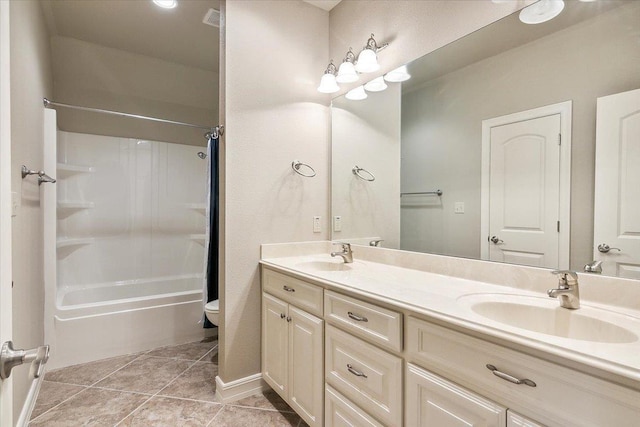 full bathroom with toilet, tile patterned flooring, double vanity, and a sink