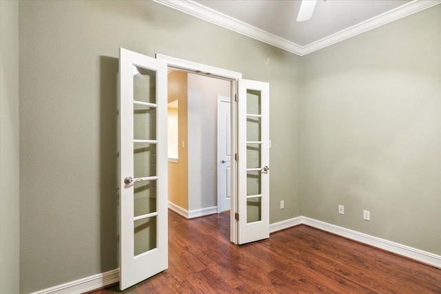 empty room featuring baseboards, ceiling fan, wood finished floors, crown molding, and french doors