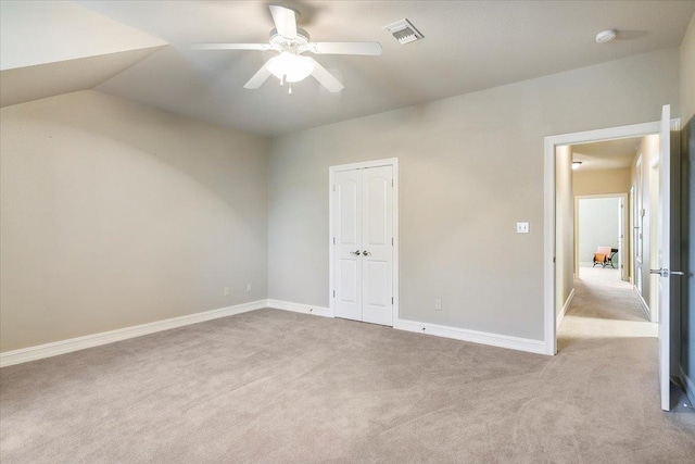 unfurnished bedroom featuring a closet, visible vents, carpet flooring, ceiling fan, and baseboards