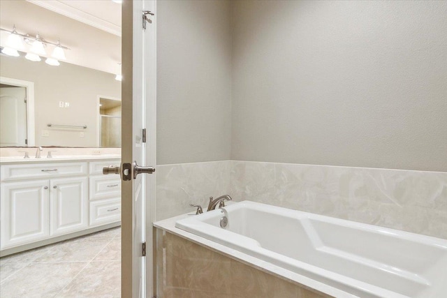 full bath with tile patterned flooring, a garden tub, and vanity