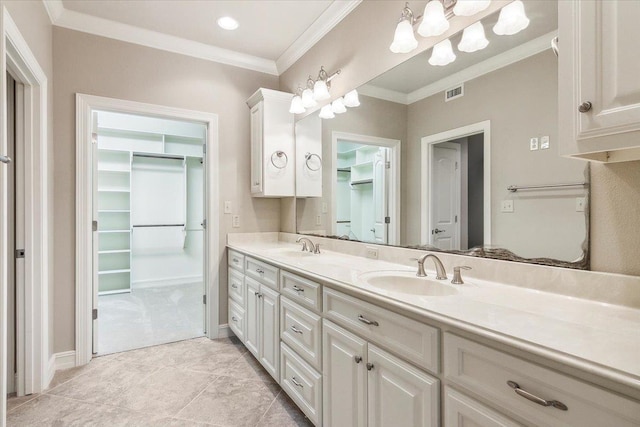 full bathroom featuring double vanity, visible vents, ornamental molding, a spacious closet, and a sink