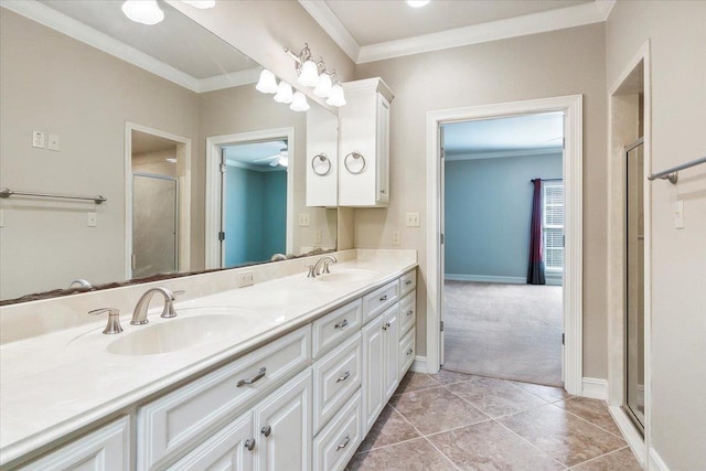 bathroom with double vanity, ornamental molding, a sink, and a shower stall