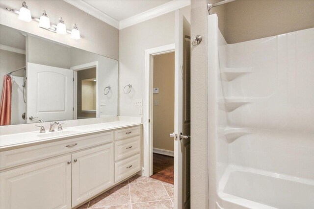 bathroom featuring ornamental molding, tile patterned flooring, shower / bath combination with curtain, and vanity