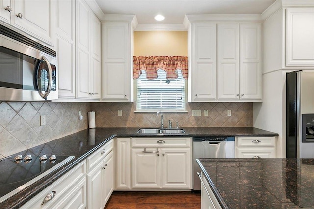 kitchen featuring stainless steel appliances, a sink, and white cabinets