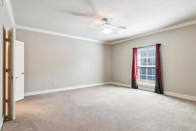 spare room featuring ceiling fan, crown molding, baseboards, and carpet flooring