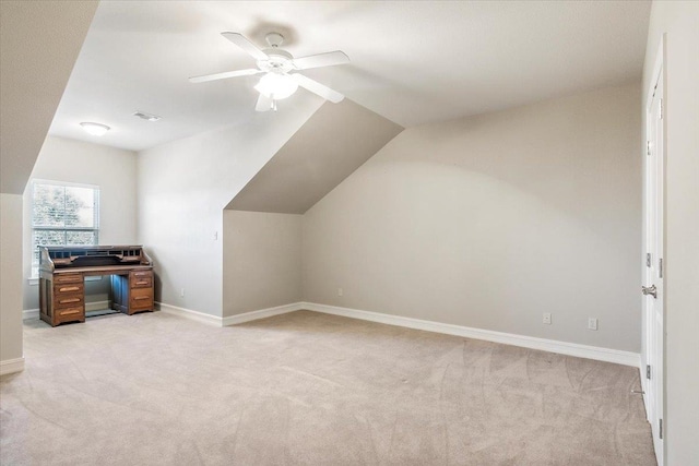 bonus room featuring light carpet, baseboards, vaulted ceiling, and a ceiling fan